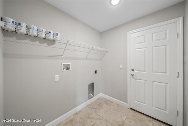 washroom featuring electric dryer hookup, washer hookup, and light tile patterned floors