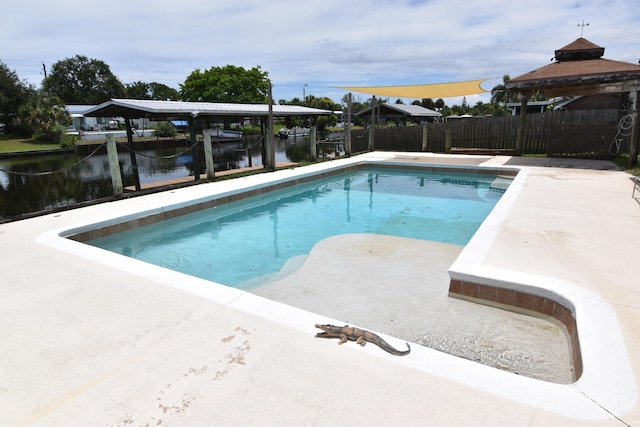 view of swimming pool featuring a water view