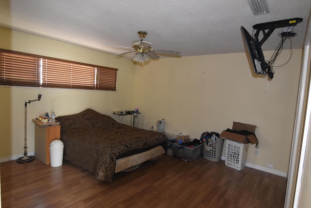 bedroom featuring a textured ceiling, ceiling fan, and dark hardwood / wood-style floors