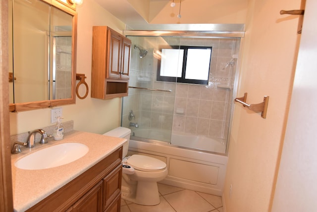 full bathroom featuring tile patterned flooring, vanity, bath / shower combo with glass door, and toilet