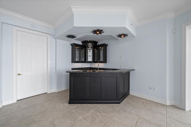 kitchen with ornamental molding, light tile patterned floors, and sink