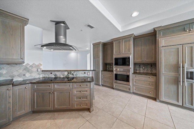 kitchen featuring black appliances, kitchen peninsula, decorative backsplash, and island exhaust hood