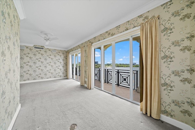 carpeted spare room featuring ceiling fan and ornamental molding