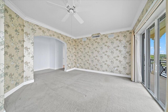 carpeted empty room with crown molding and ceiling fan