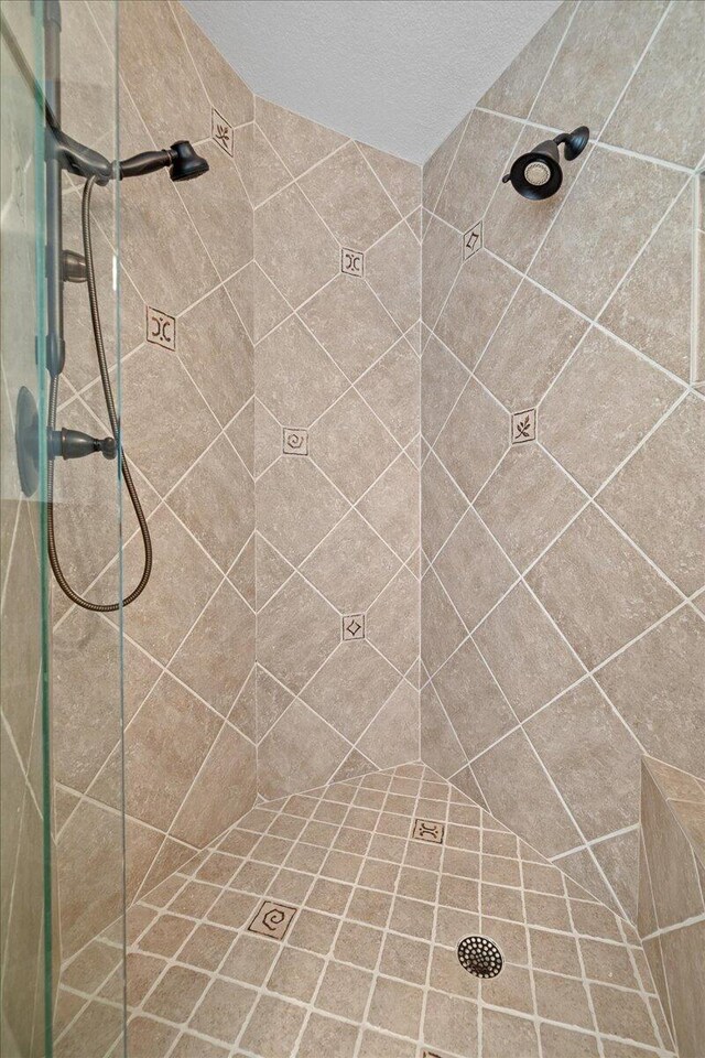 bathroom with tiled shower