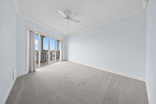 empty room with ceiling fan, ornamental molding, and carpet floors