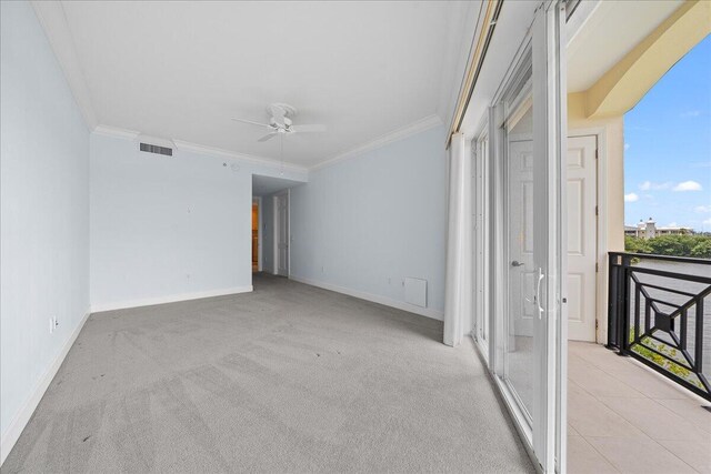 carpeted empty room featuring ornamental molding, plenty of natural light, and ceiling fan