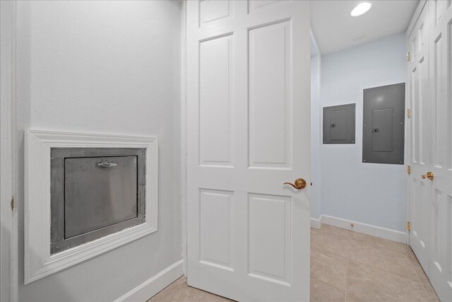 room details featuring electric panel and tile patterned flooring