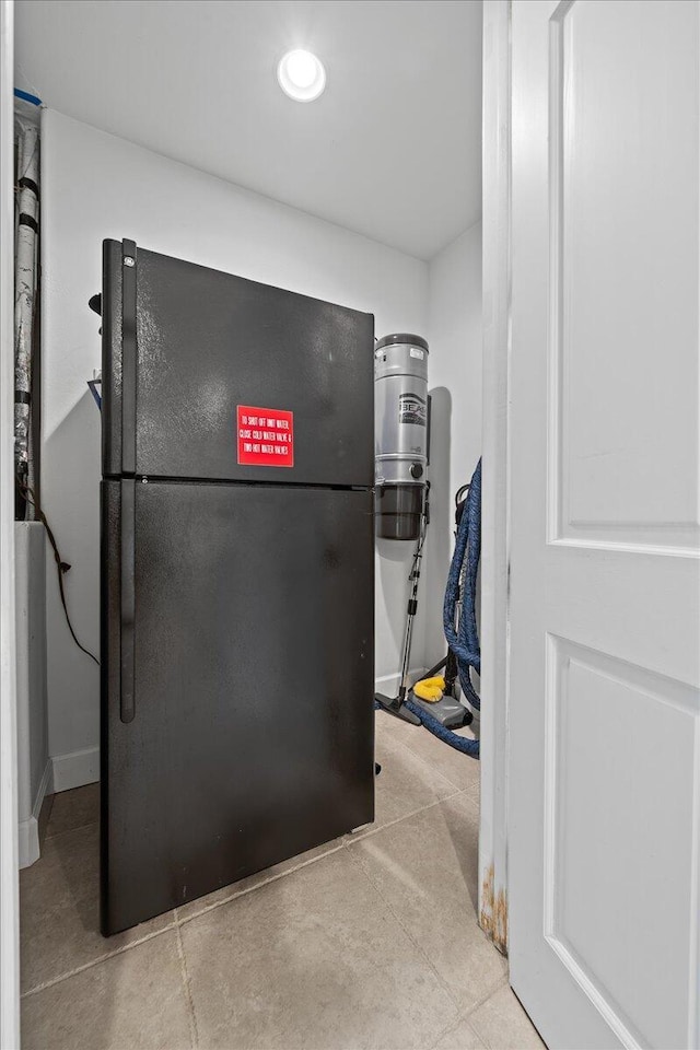 kitchen featuring freestanding refrigerator and recessed lighting