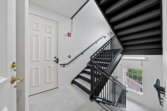 stairway featuring concrete floors