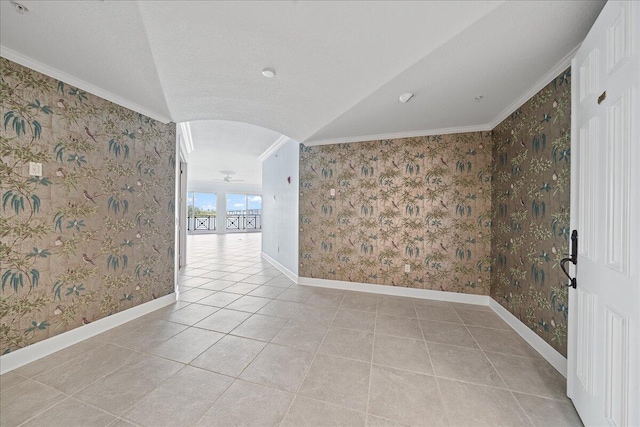 tiled empty room featuring ornamental molding