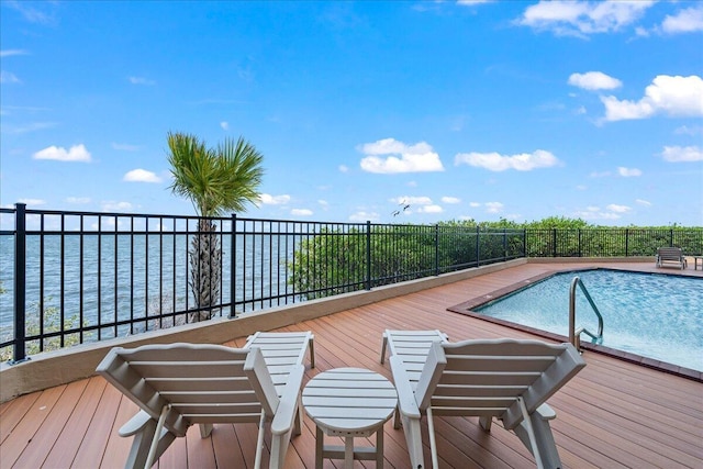 view of pool featuring a water view, fence, and a fenced in pool