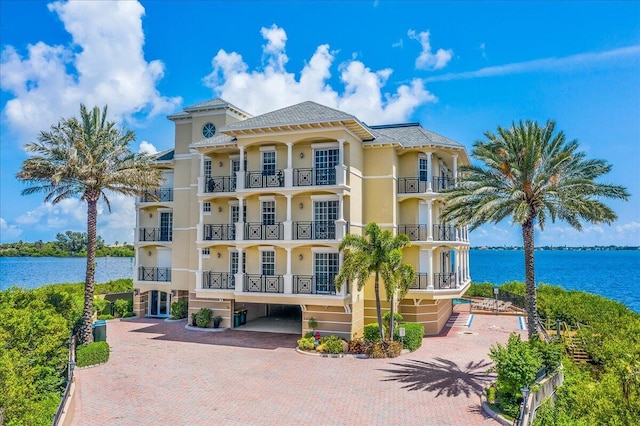 view of property featuring a water view and stairs