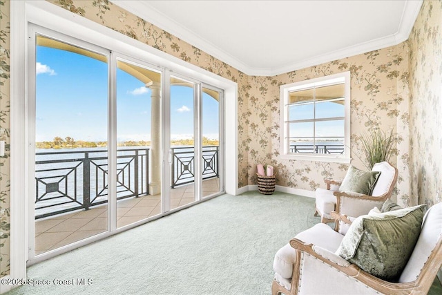 sitting room featuring wallpapered walls, carpet, baseboards, and crown molding