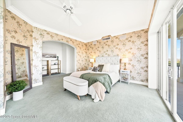 bedroom with carpet, arched walkways, baseboards, and wallpapered walls