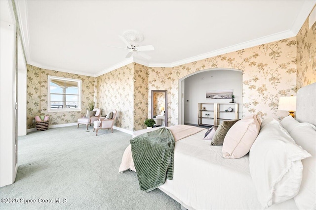 bedroom featuring arched walkways, carpet floors, baseboards, wallpapered walls, and crown molding