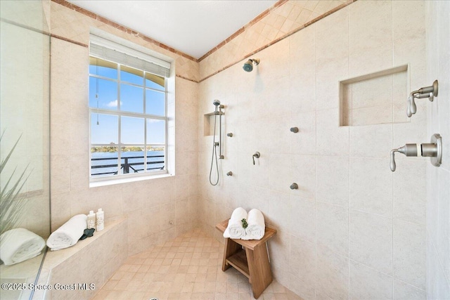 full bath featuring a water view and tiled shower