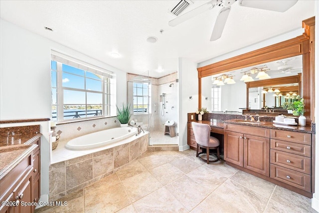 bathroom with visible vents, ceiling fan, vanity, a shower stall, and a bath