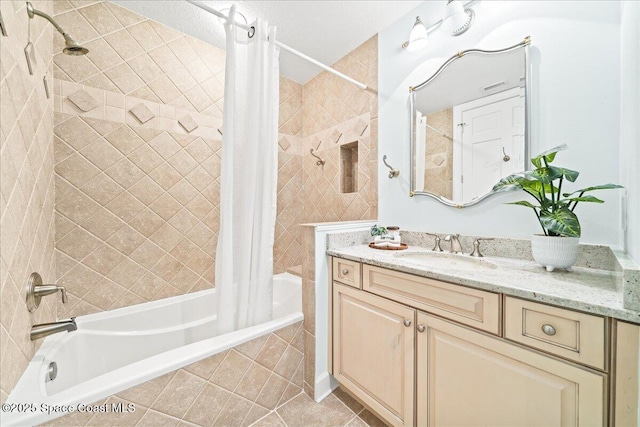 bathroom featuring tiled shower / bath combo, vanity, and tile patterned floors