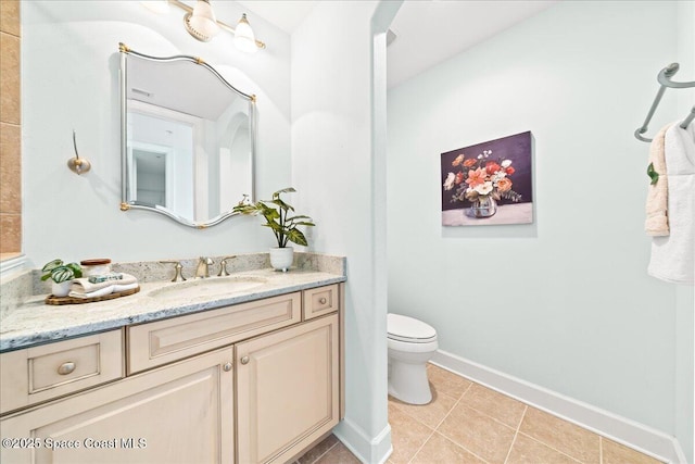 bathroom featuring toilet, tile patterned floors, baseboards, and vanity