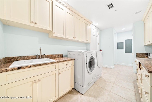 laundry area with cabinet space, electric panel, visible vents, washer and dryer, and a sink