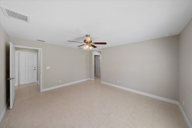 spare room with ceiling fan and light tile patterned flooring