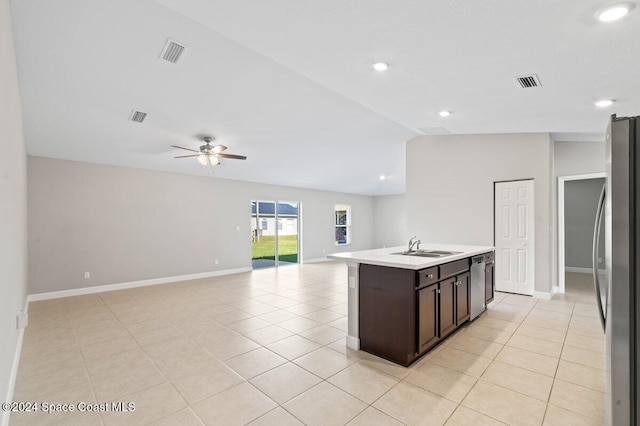 kitchen featuring a kitchen island with sink, appliances with stainless steel finishes, light tile patterned floors, ceiling fan, and dark brown cabinets