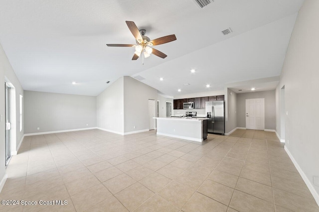 unfurnished living room featuring ceiling fan, vaulted ceiling, and light tile patterned floors