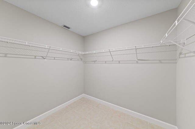 spacious closet featuring tile patterned floors