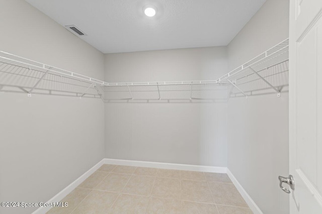 walk in closet featuring tile patterned flooring