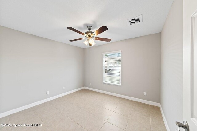 unfurnished room with ceiling fan and light tile patterned floors