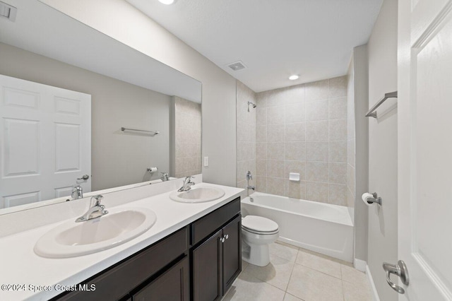 full bathroom with toilet, tiled shower / bath combo, tile patterned flooring, and vanity