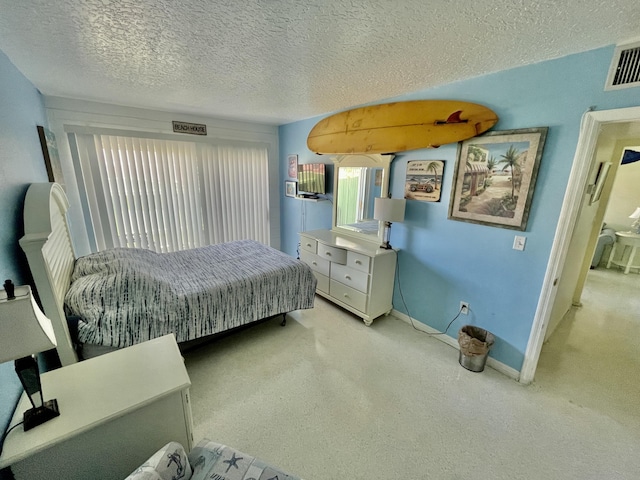 carpeted bedroom with a textured ceiling