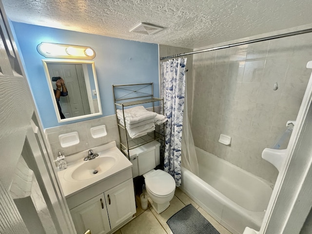 full bathroom with tile patterned floors, a textured ceiling, toilet, vanity, and shower / tub combo