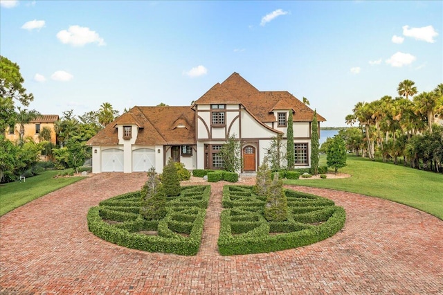 view of front of house with a garage and a front lawn