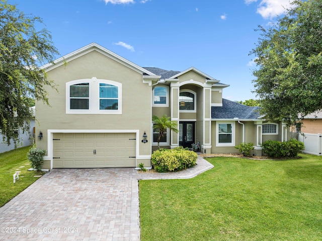 view of front facade with a front yard and a garage