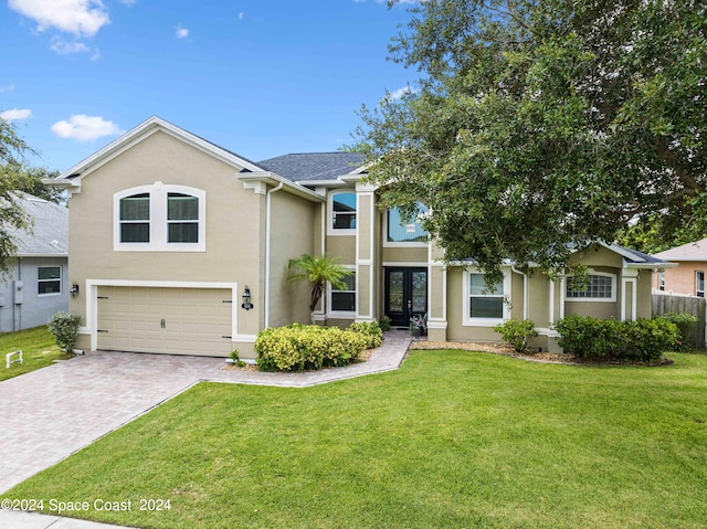 view of front of property featuring a front lawn and a garage