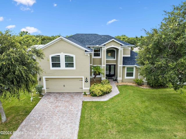 view of front of property with a front yard and a garage