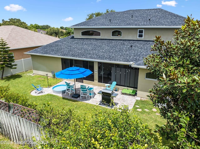 back of house featuring an outdoor fire pit, a yard, and a patio area