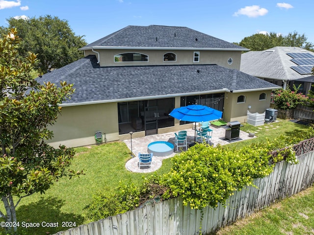 rear view of house featuring a lawn, outdoor lounge area, solar panels, and a patio area