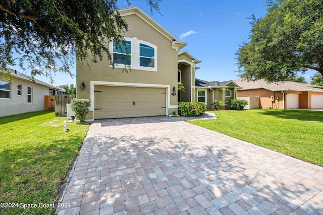 front facade featuring a garage and a front yard