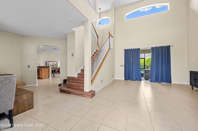 tiled foyer entrance with a high ceiling