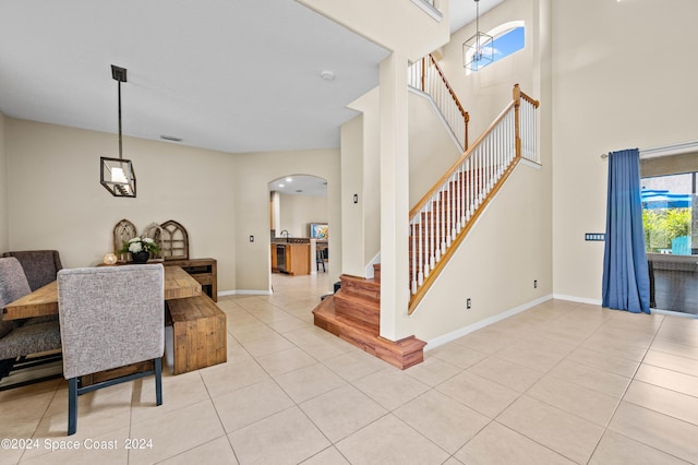 tiled dining space with a high ceiling