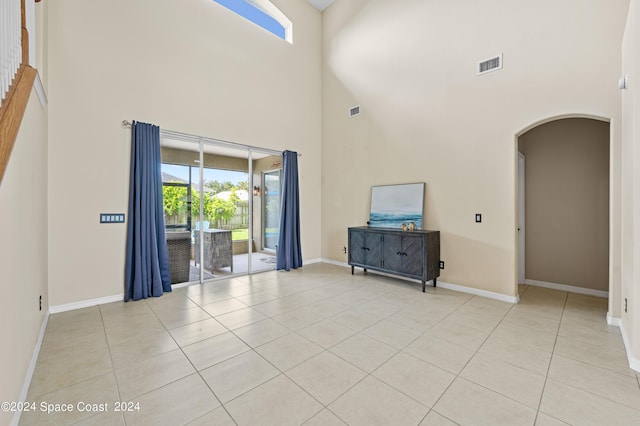 unfurnished living room featuring light tile patterned flooring