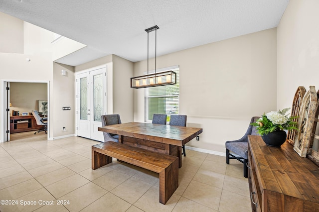 tiled dining room with a textured ceiling