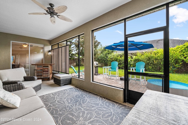 sunroom with ceiling fan and plenty of natural light