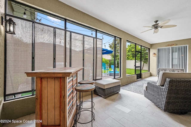 sunroom with ceiling fan