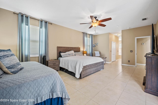 bedroom featuring light tile patterned floors and ceiling fan