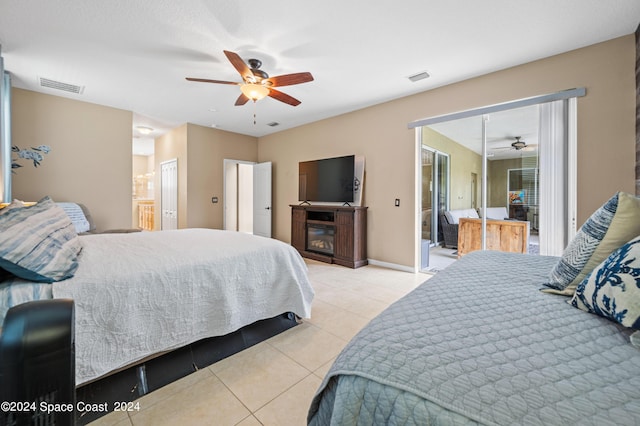 tiled bedroom with ceiling fan and ensuite bathroom