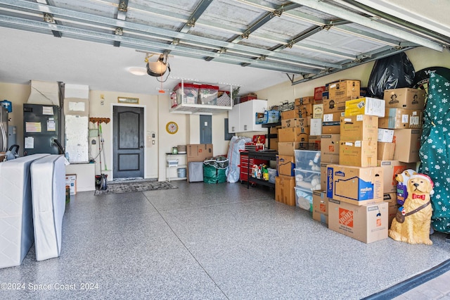 garage featuring a garage door opener and electric panel